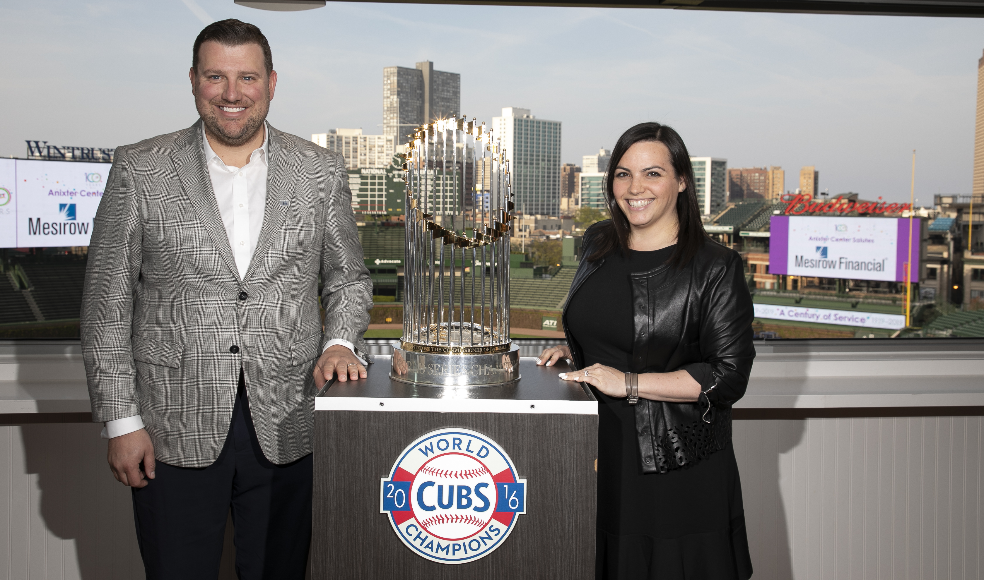 man and woman with world series trophy