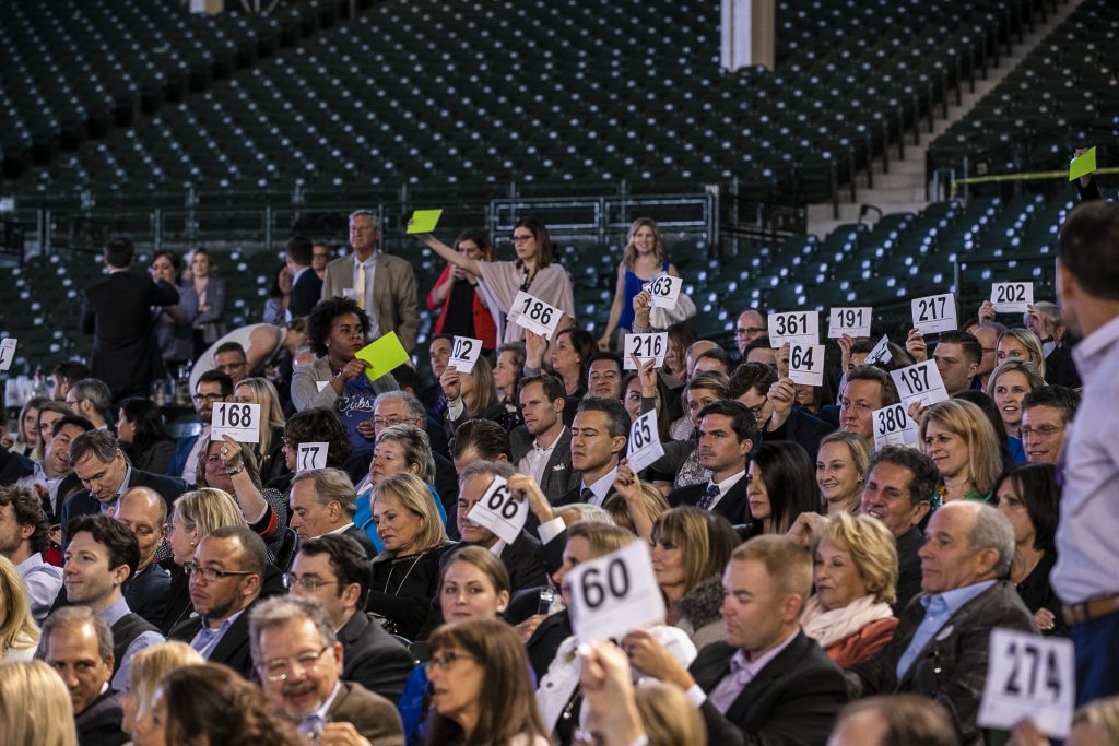 Gala guests bidding at the auction in the Wrigley Field stadium