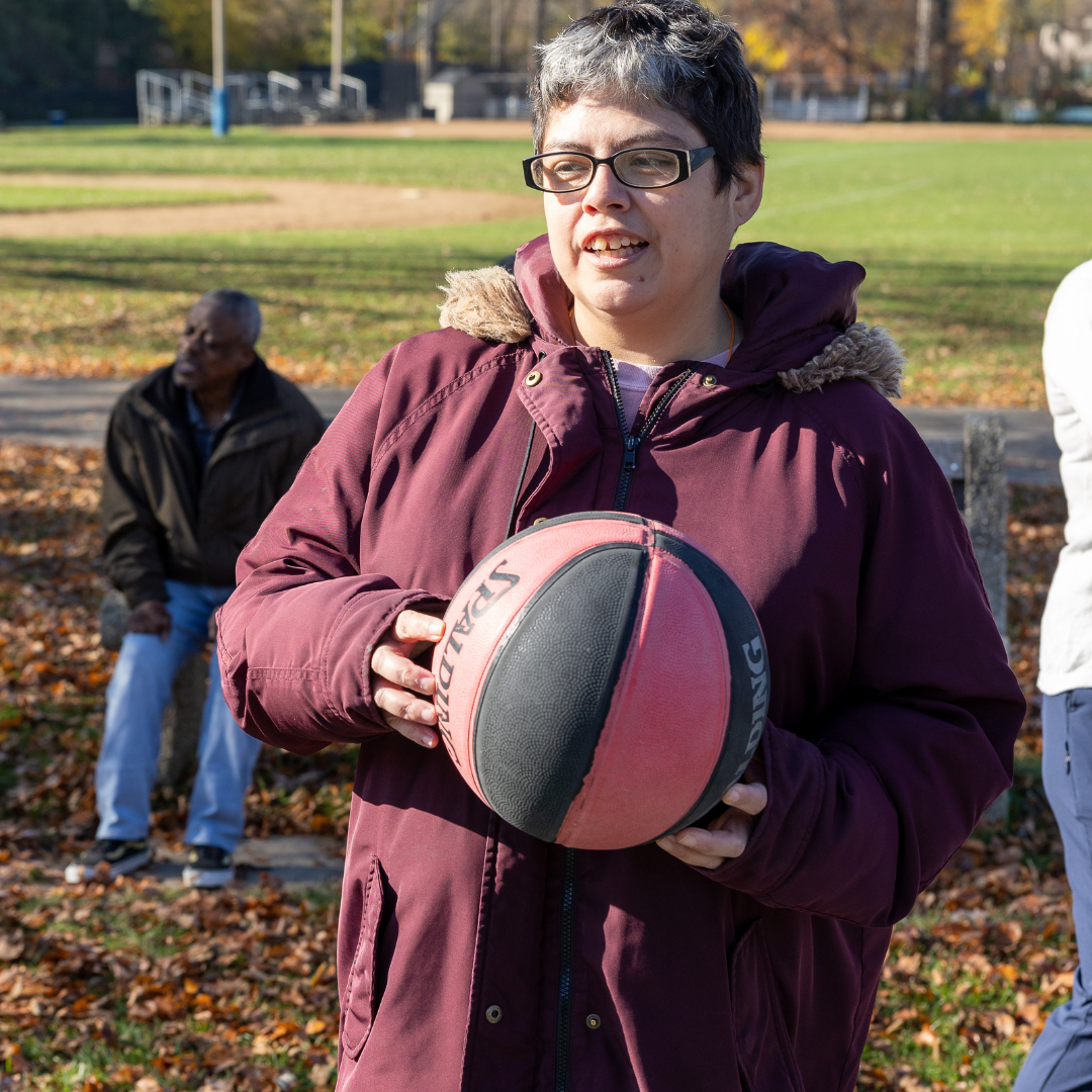 A woman holding a basketball