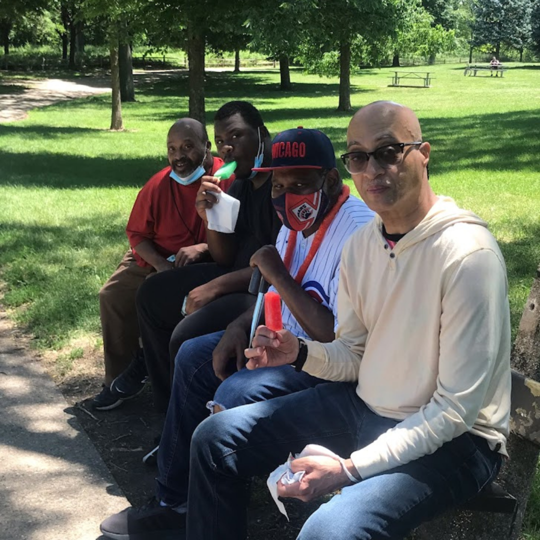 A group of four people enjoying time in a park